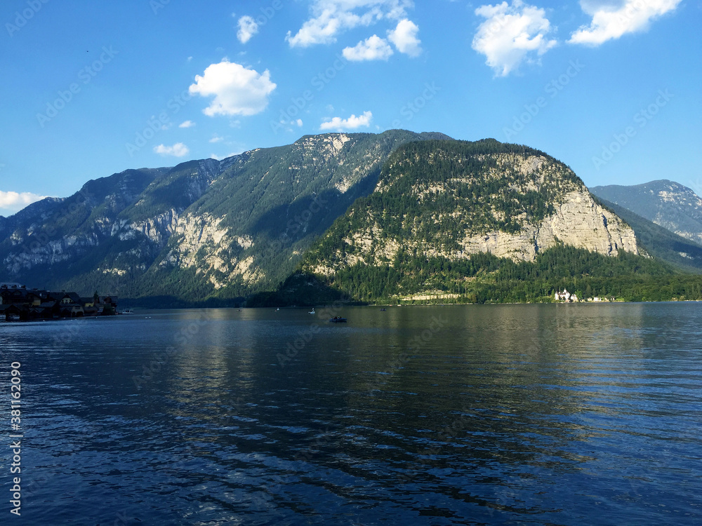 landscape of lake and mountains against blue sky at sunny day in Hallstatt Upper Austria