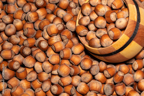 Filtered image of Hazelnuts in a wooden bowl