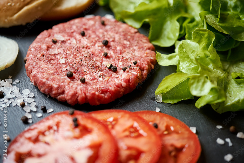 fresh beef for burger on the table with lettuce onion and bread fresh beef for burger on the table with lettuce onion and bread