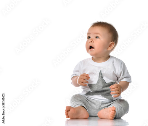 Happy baby boy sitting and laughing