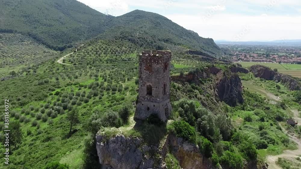 Aerial view of medieval tower on the top of the mountain. Drone viewpoint. Slow motion Aerial view of medieval tower on the top of the mountain. Drone viewpoint. Slow motion