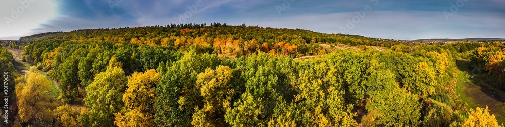 Panoramic aerial view over colorful green and orange autumn forest in countryside in Samara region, Russia