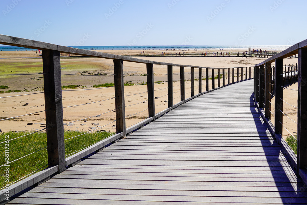 wooden pontoon sea access walkway on sandy beach atlantic ocean horizon in Jard sur Mer in france