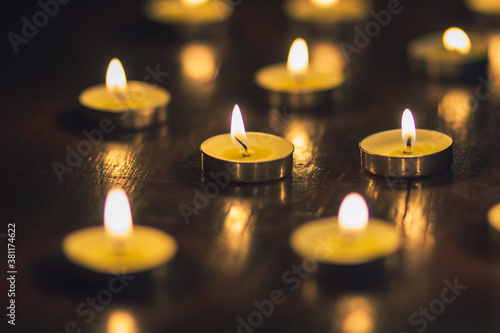 Lots of lighted candles on a wooden table romantic date