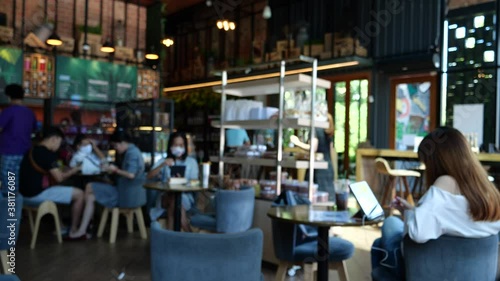  Blurred background coffee shop for inserting text.Breakfast, lunch, cafe, restaurant, Everyday life is in full swing. Visitors cafe weekends. Have good time. Girl sitting table use tablet on her hand