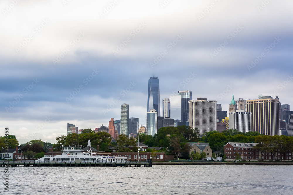 NY / USA - September 26 2020: View on a ferry going from Governor's Island over downtown Manhattan skyline NY / USA - September 26 2020: View on a ferry going from Governor's Island over downtown Manhattan skyline