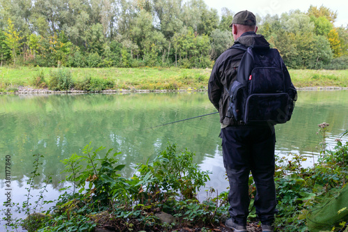 Autumn fishing. The man is fishing with a fishing rod. Back view. © EUDPic