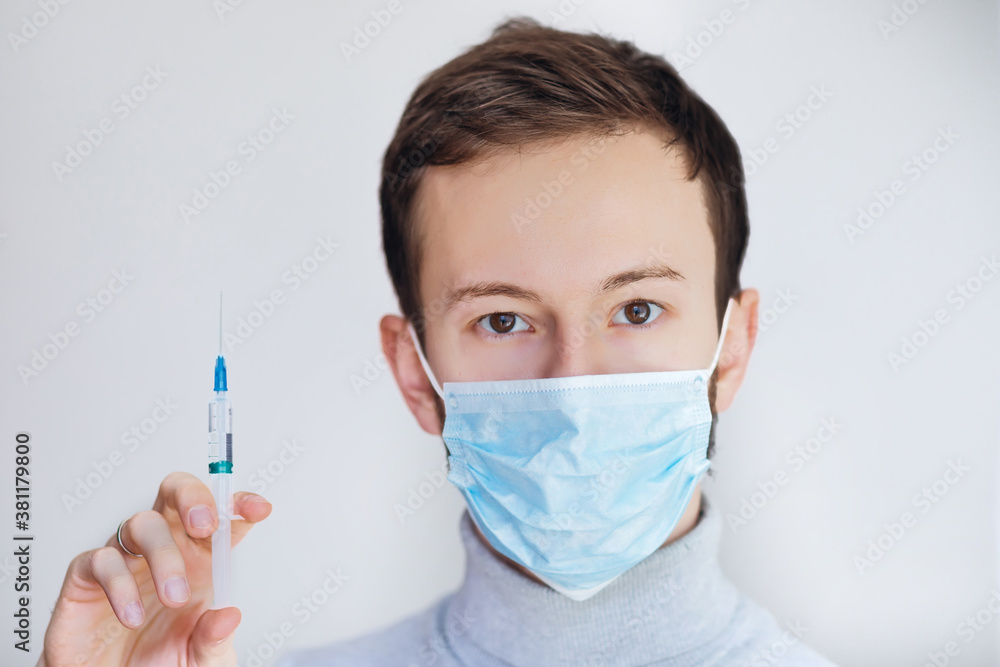 doctor with virus vaccine and syringe looking at camera doctor with virus vaccine and syringe looking at camera