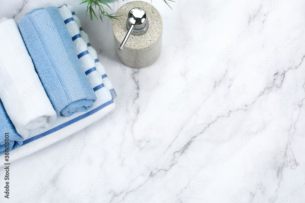 Towels stack and soap dispenser on bathroom table top view empty space ...