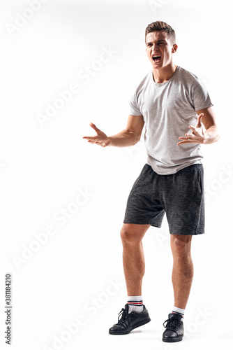 Athletic man on a light background in full growth and jogging charging shorts sneakers t-shirt © SHOTPRIME STUDIO