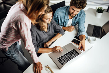 Group of young people working or studying together. Hipster team in coworking. Young modern business colleagues. Startup concept