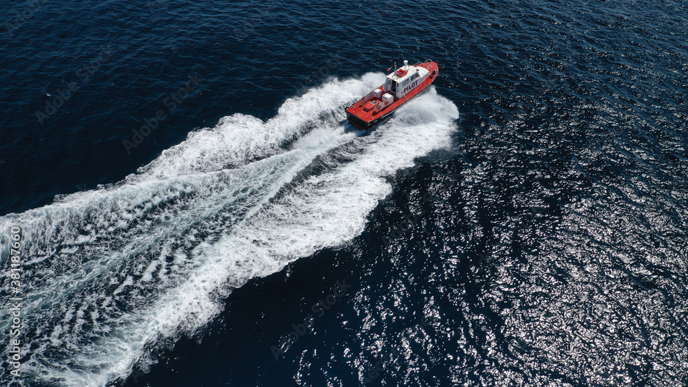 Aerial drone photo of red pilot boat cruising in high speed in Mediterranean deep blue sea offering navigational aid to ships Aerial drone photo of red pilot boat cruising in high speed in Mediterranean deep blue sea offering navigational aid to ships