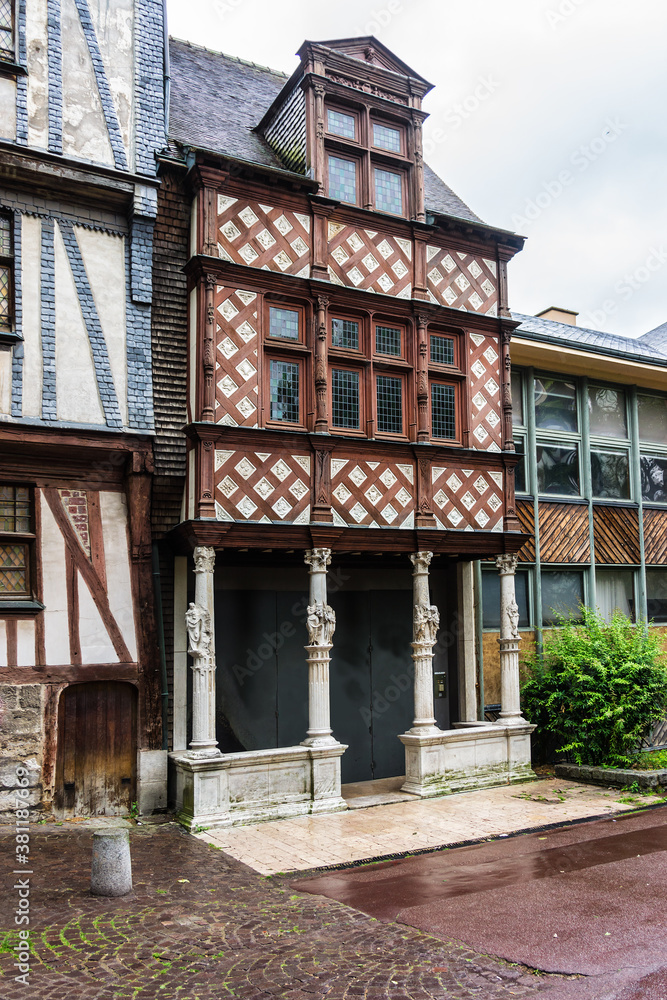 Typical Old Half-timbered houses at Rue Eau de Robec in Rouen on a rainy day. Rue Eau-de-Robec is one of the main tourist streets of Rouen. Upper Normandy, France.