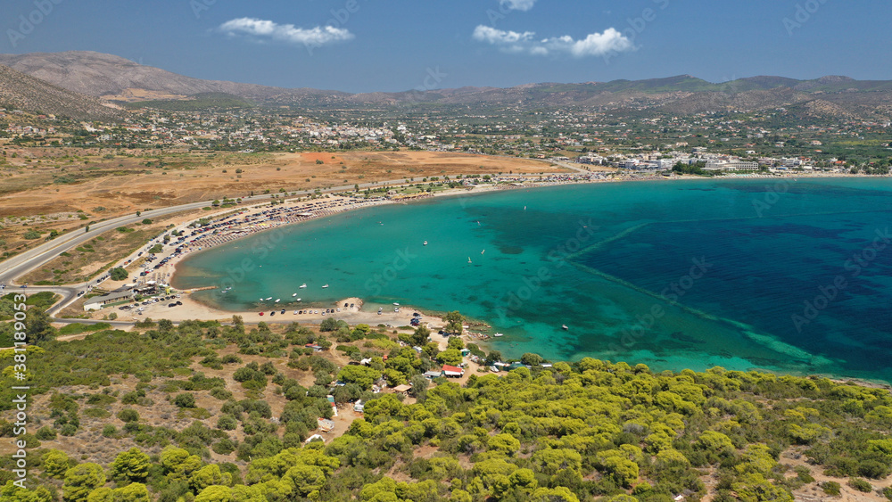 Aerial drone photo of famous organised beach and bay of Anavysos with crystal clear emerald sea popular to water sports, Athens riviera, Attica, Greece
