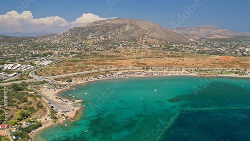 Aerial drone photo of famous organised beach and bay of Anavysos with crystal clear emerald sea popular to water sports, Athens riviera, Attica, Greece