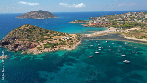 Aerial drone photo of famous islet, beach and bay of Agios Nikolaos in Anavysos area with crystal clear emerald sea, Athens riviera, Attica, Greece