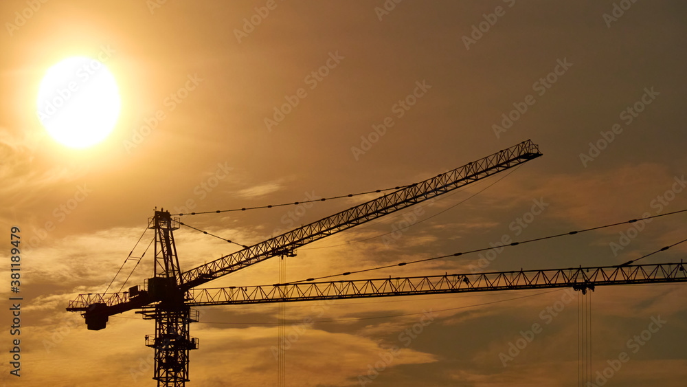 Construction crane on the background of a beautiful sky at sunset. general plan