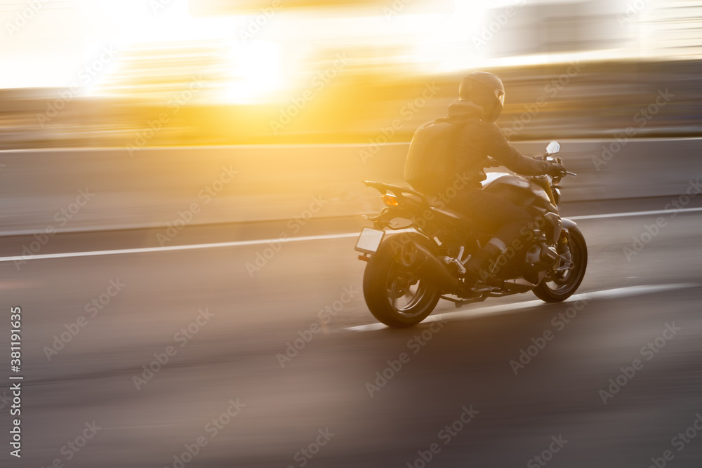 A biker on a motorcycle in the background of an order on a background blurred by speed.
