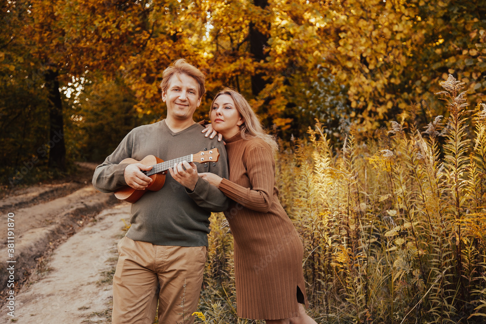 Cute couple have a good time together in the beautiful autumn park Cute couple have a good time together in the beautiful autumn park