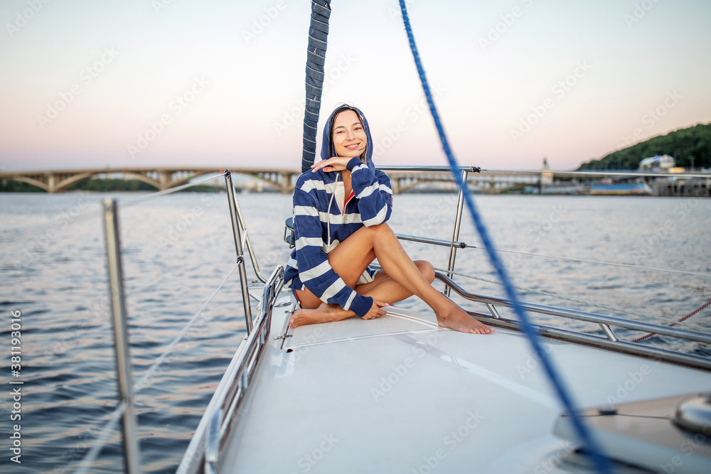 Beautiful girl resting on a yacht at sunset Beautiful girl resting on a yacht at sunset