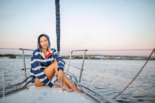 Beautiful girl resting on a yacht at sunset © Maygutyak