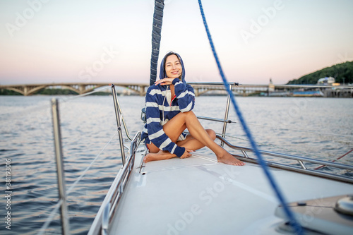 Beautiful girl resting on a yacht at sunset © Maygutyak