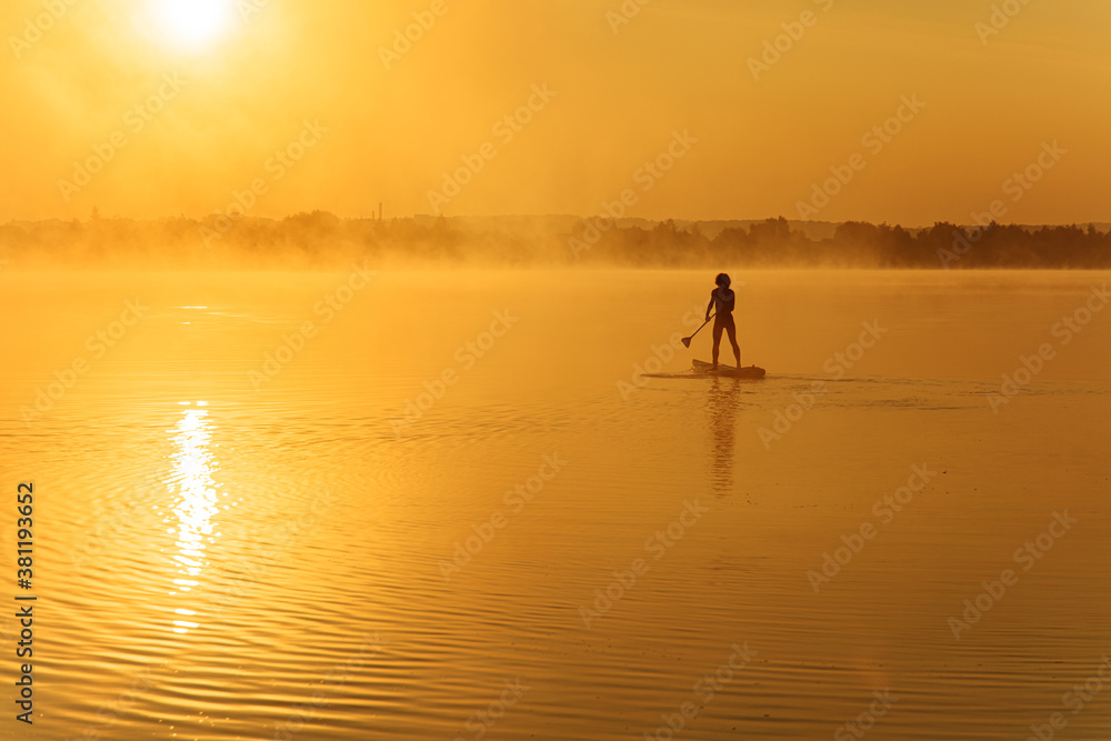 Strong healthy man floating alone on paddle board