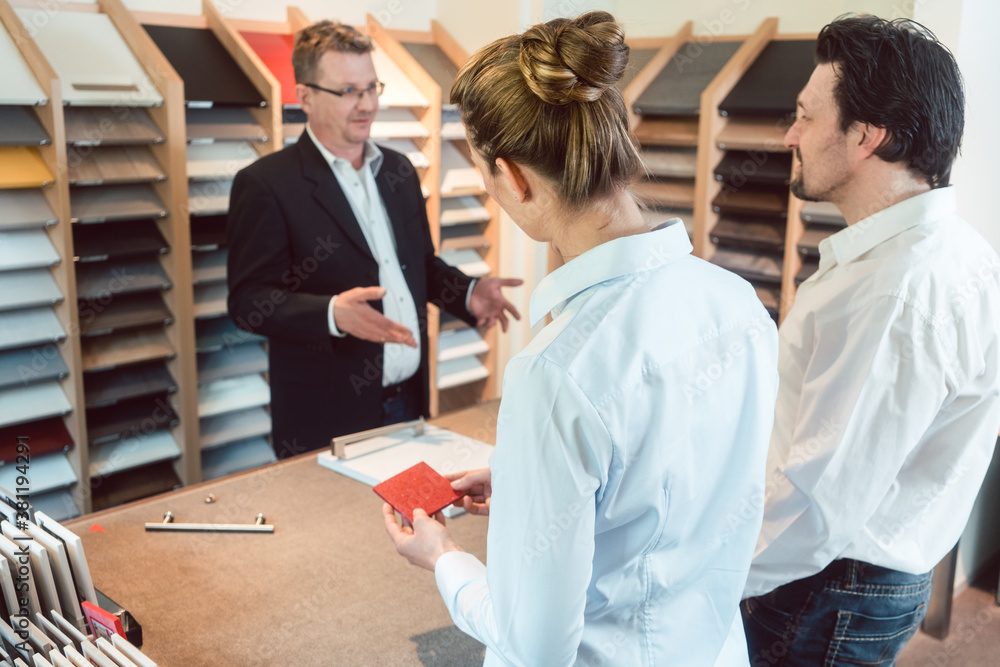 Woman, man, and expert discussing details of new kitchen finish Woman, man, and expert discussing details of new kitchen finish