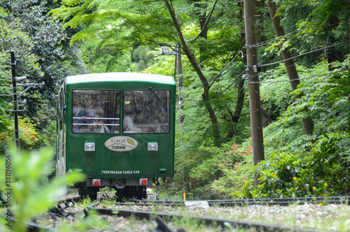 Tsukuba, Japan - April 30: A group of tourists are riding a green cable car through the forest to the top of Mount Tsukuba during Golden Week holiday (April 30, 2018)
