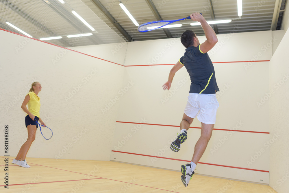 couple with squash rackets indoor training club couple with squash rackets indoor training club