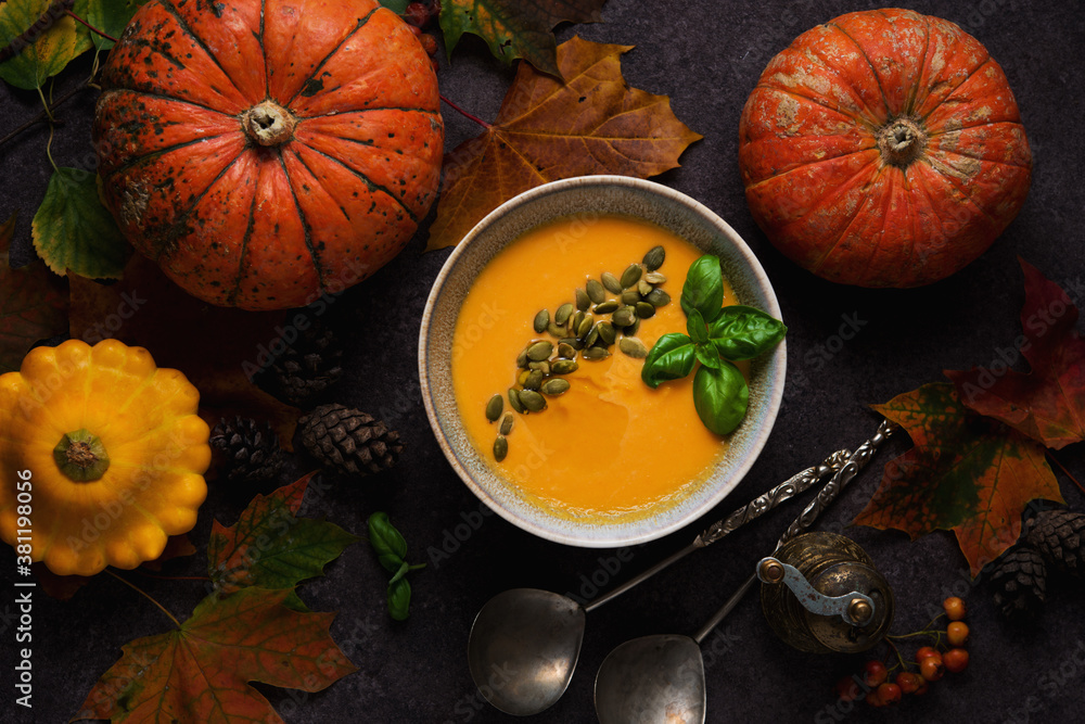 Thanksgiving concept with pumpkin, pumpkin soup and fallen leaves, top view Thanksgiving concept with pumpkin, pumpkin soup and fallen leaves, top view