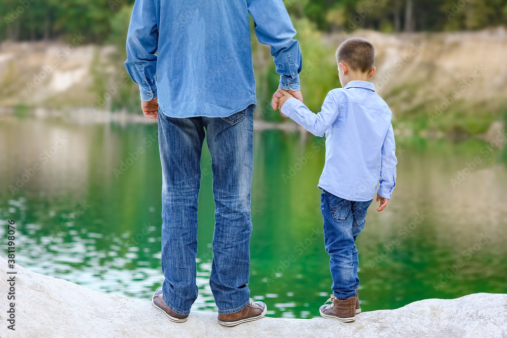 A Hands of parent and child in nature in the park travel A Hands of parent and child in nature in the park travel