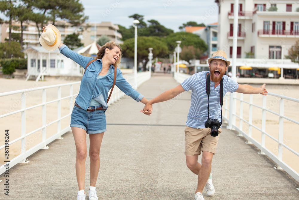 Fototapeta premium beautiful couple walking on the beach having fun
