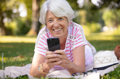 attractive senior woman sitting on the lawn