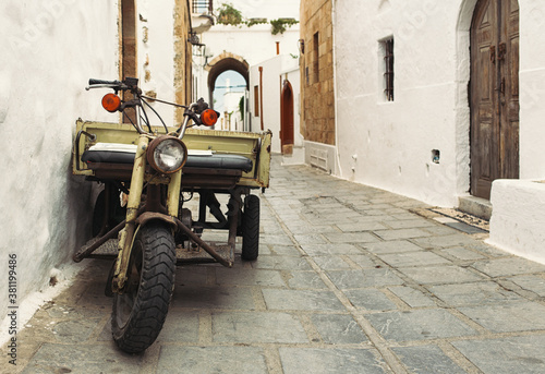 old motor scooter on the ancient streets of the village of Lindos on the island of Rhodes  Greece 