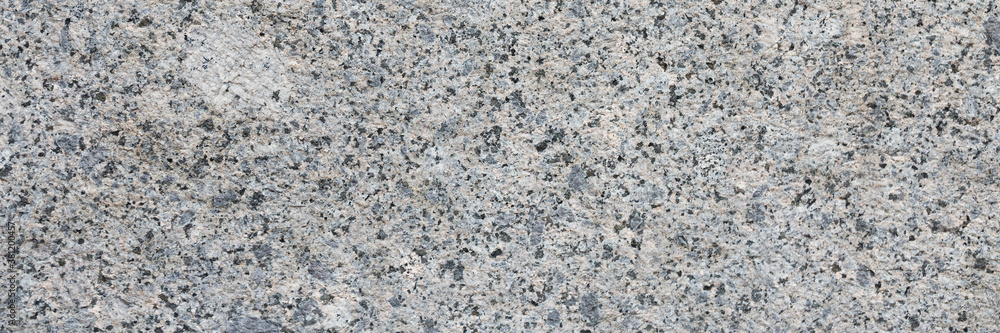 Granite texture. Natural gray granite with a grainy pattern. Stone background. Solid rough surface of rock. Durable construction and decoration material. Close-up. Granite texture. Natural gray granite with a grainy pattern. Stone background. Solid rough surface of rock. Durable construction and decoration material. Close-up.