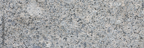 Panel kuchenny z motywem Granite texture. Natural gray granite with a grainy pattern. Stone background. Solid rough surface of rock. Durable construction and decoration material. Close-up.