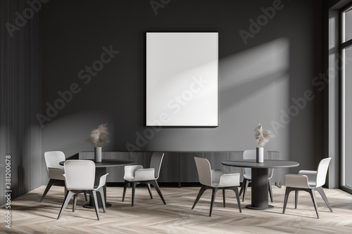 Stylish dark gray cafe interior with poster and sofa