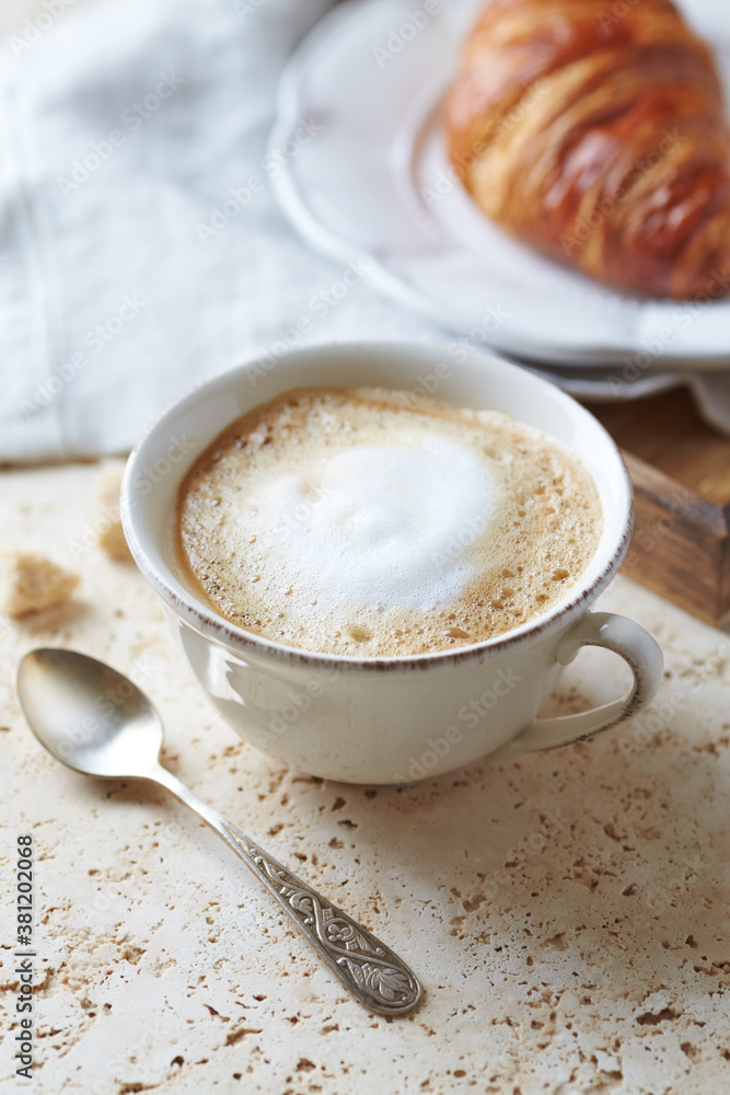 Coffee with milk on bright stone background. Close up. Coffee with milk on bright stone background. Close up.