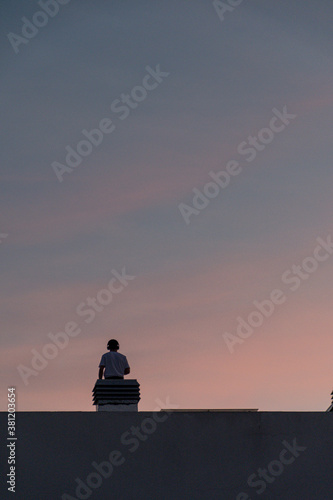 silhouette of a person at sunset in a roof