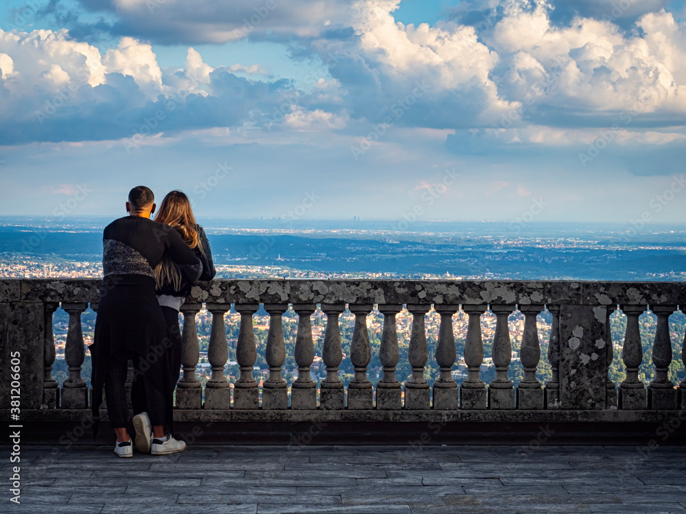 Couple of lovers on the balcony of Sacro Monte in Varese ( the plate on the railing says that Pope Vojtyla blesses the Po Valley during his visit on that balcony)
