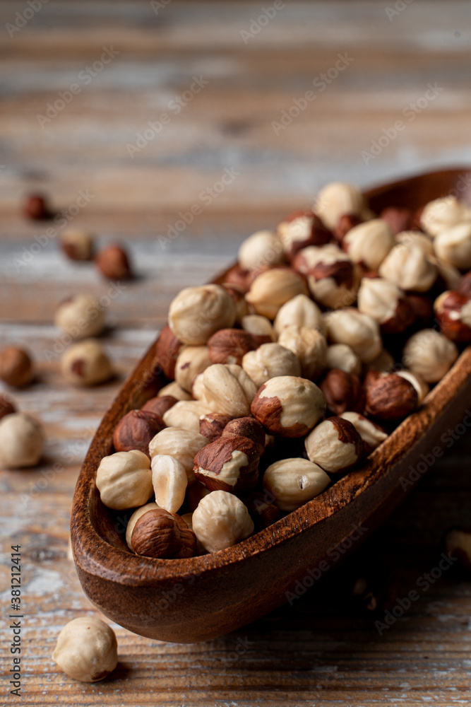 Full wooden rustic bowl of roasted hazelnuts on a wooden table, market catalogue photo Full wooden rustic bowl of roasted hazelnuts on a wooden table, market catalogue photo