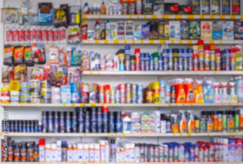 Defocus Blurred background shop window of auto cosmetics store and accessories for cars, many multi-colored bottles, background