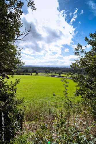 A scenic view of a  countryside field on a sunny day