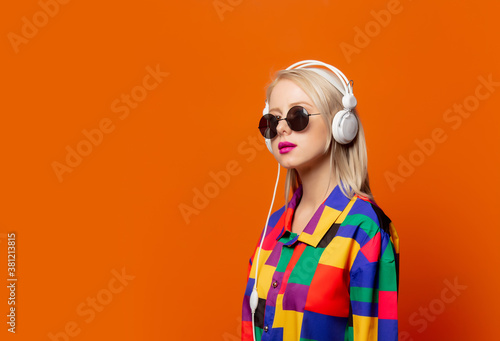 Obraz na plátně Style blonde in 90s clothes with headphones