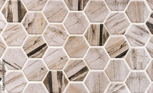 Beige-and-brown ceramic tile in the form of honeycombs. Hexagonal floor tiles.
