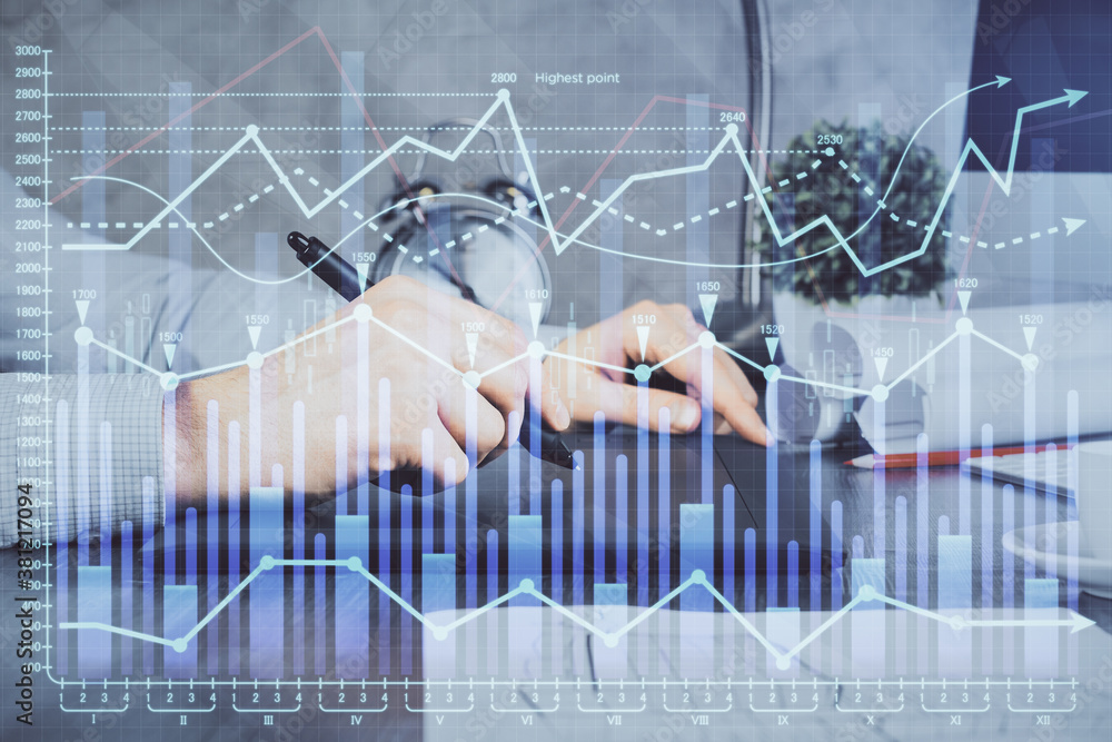 Double exposure of man's hands holding and using a phone and financial graph drawing. Analysis concept. Double exposure of man's hands holding and using a phone and financial graph drawing. Analysis concept.
