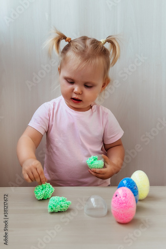 little girl playing with colorful play dough.  child having fun at home. 