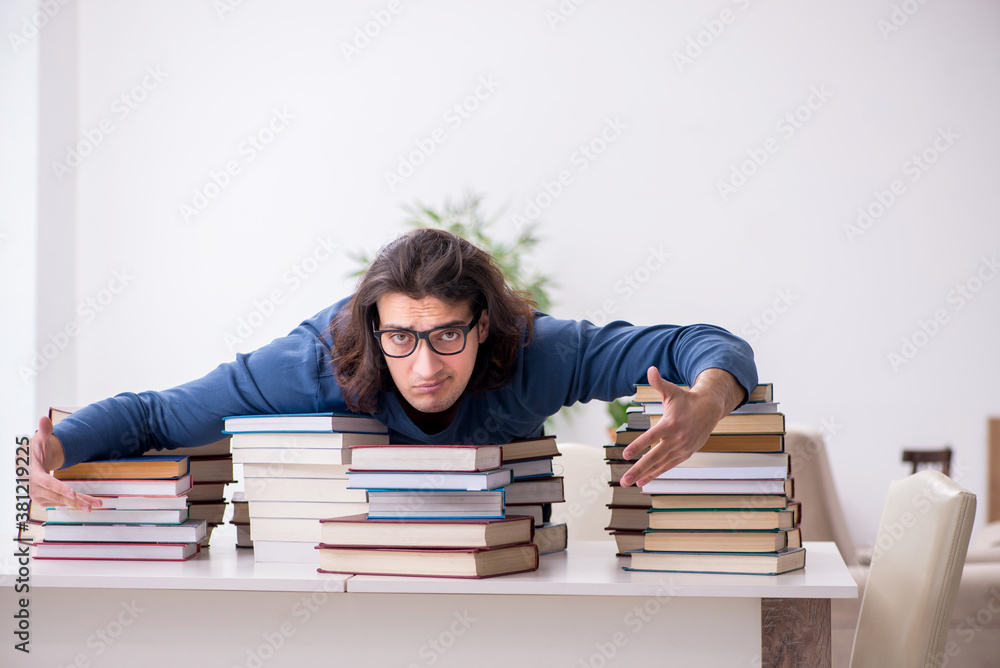 Young male student preparing for exams at home Young male student preparing for exams at home