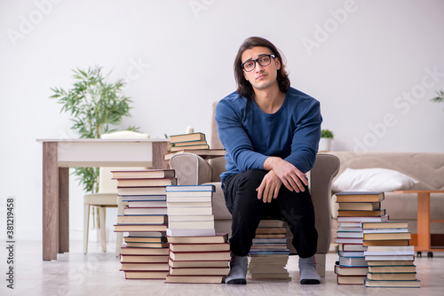 Young male student preparing for exams at home